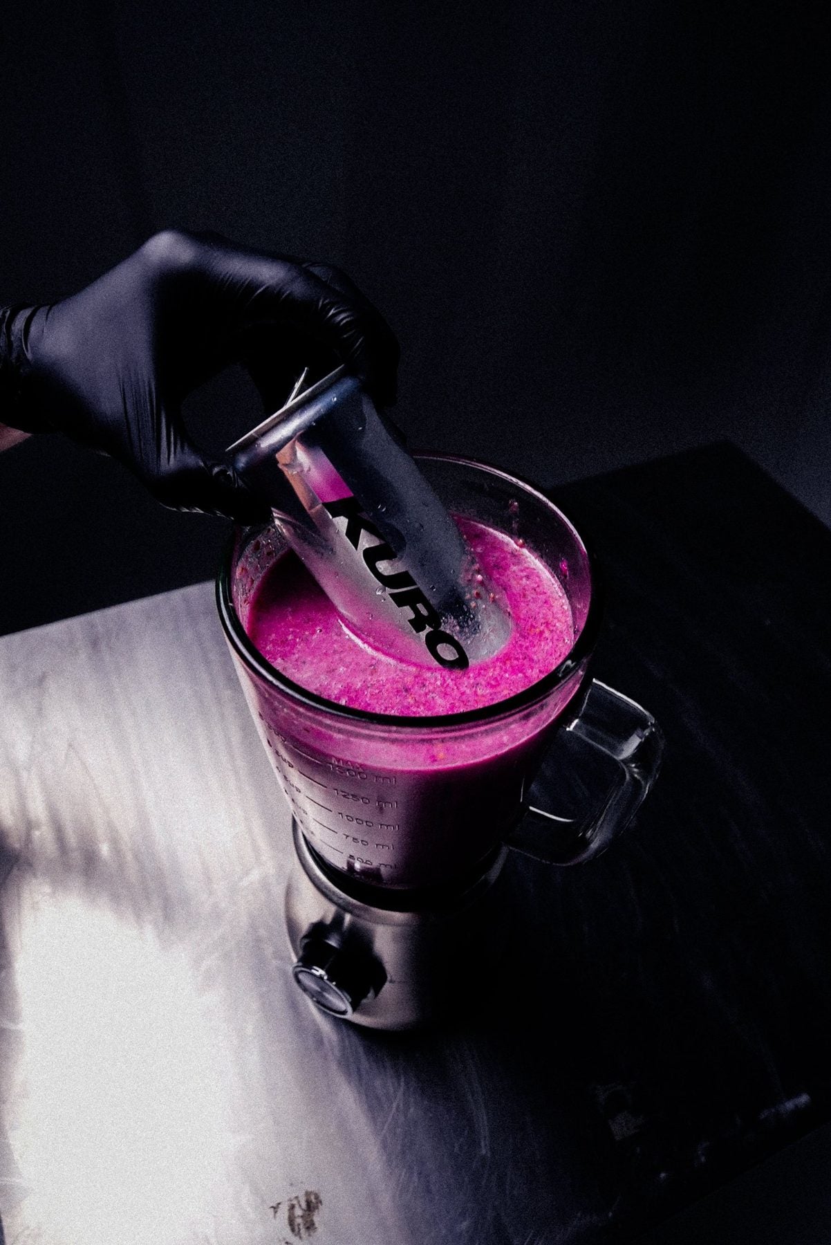 A KURO can pushed into a blender of dragonfruit