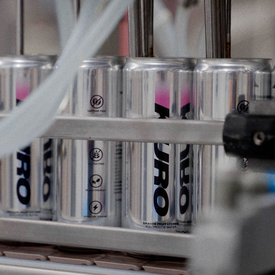 KURO cans moving down the filling line